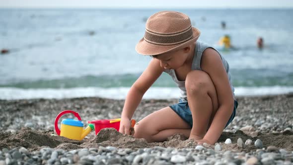 Little Cute Boy Playing with Sand Using Toy on Beach Enjoying Summer Travel Vacation Activity