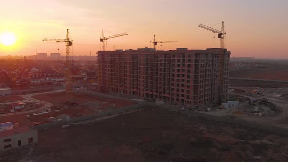 Construction Site in the Middle of the City and Private Houses at Sunset in .