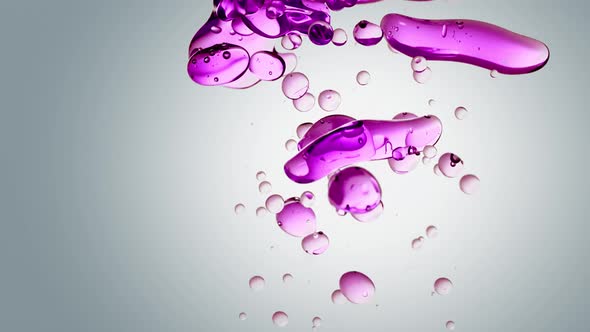 Transparent Cosmetic Purple Oil Bubbles and Shapes on White Background