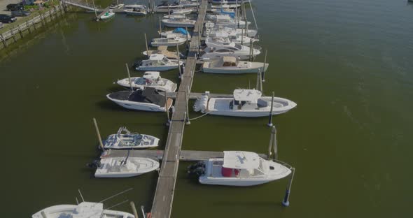 Slow Tilt Up of Boats Docked at a Small Marina in Cold Spring Harbor Long Island