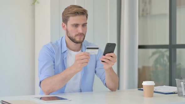 Young Creative Man Making Online Payment on Smartphone