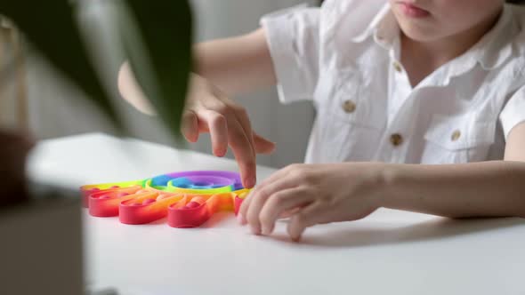 Child Play with Pop It Sensory Toy