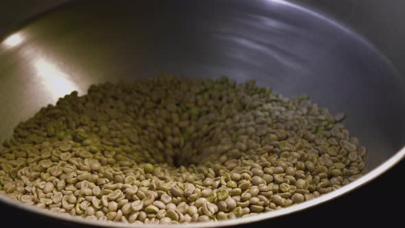 Barista Pours Green Unroasted Arabica Beans Into the Roaster