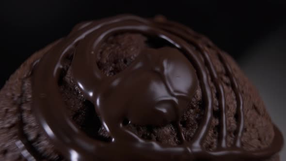 Chocolate cake brownie rotating in front of camera on black background