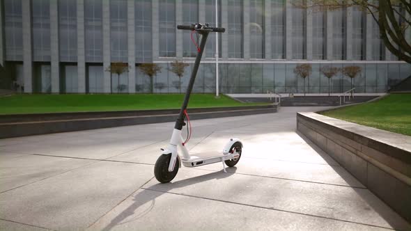 White Electric Scooter in Urban Park in Summer