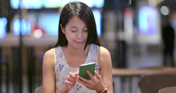 Woman Use of Mobile Phone Inside Restaurant