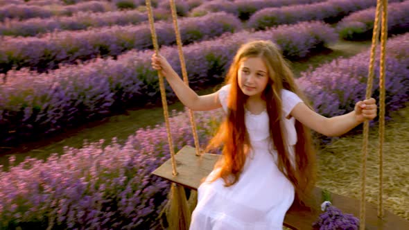 Girl Riding a Swing in a Lavender Field