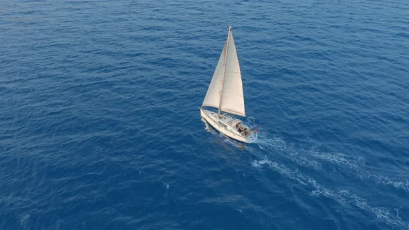 Aerial View. Yacht Sailing on Open Sea at Sunny Windy Day