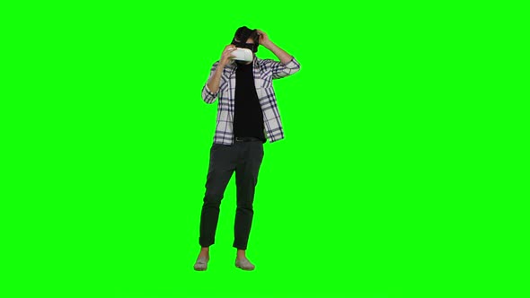 Surprised Man Uses Virtual Reality Goggles. Green Screen
