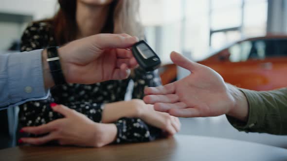 The Dealership Manager Hands Over the Keys to the New Car to the Customer