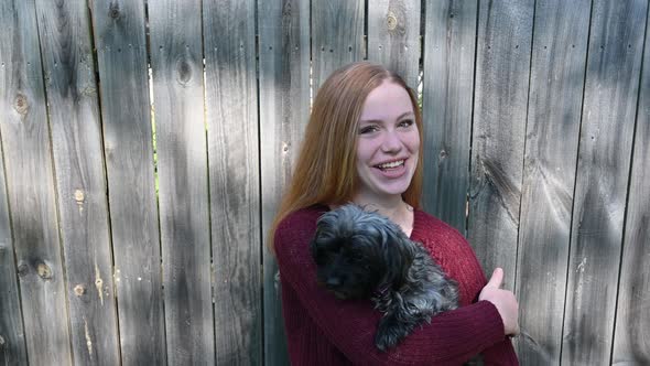 Genuine love and affection for her pet. Madelyne has a big laugh and then smiles at the camera.