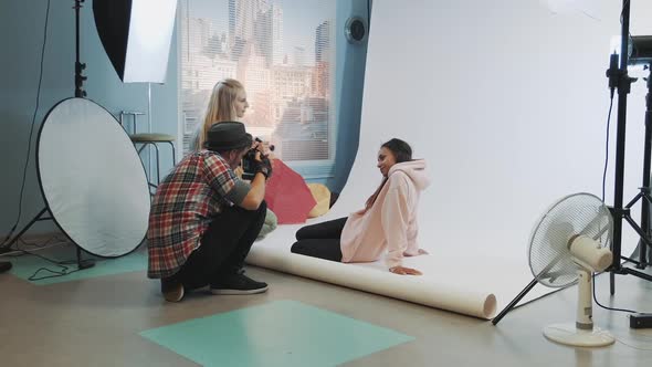 Photographer Taking Photos of Black Model in a Moment Makeup Artist Applying Makeup on Pretty Woman