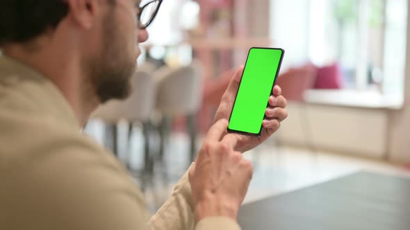 Young Man Using Smartphone with Chroma Screen