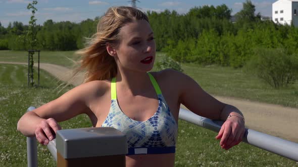 A Fit Beautiful Woman Looks Around at an Outdoor Gym - Closeup