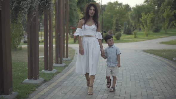 Wide Shot Positive Beautiful Middle Eastern Woman Walking Cute Little Boy Summer Park