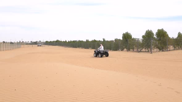 Bedouin Rides on an ATV in the Desert