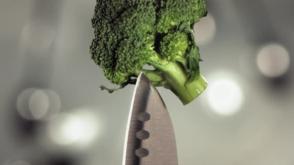 Fresh Broccoli Falling Down on Knife Stuck