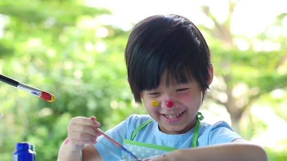 Cute Asian Child And Mother Painting Together