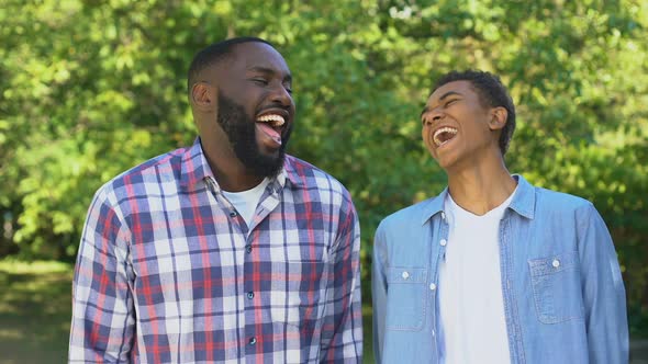 Positive Son and Father Laughing Outdoors Joking Having Fun Together, Relations