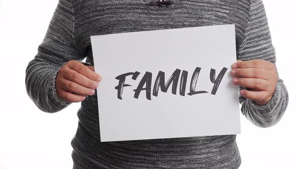 A person holding a sign with the message and the word "family"