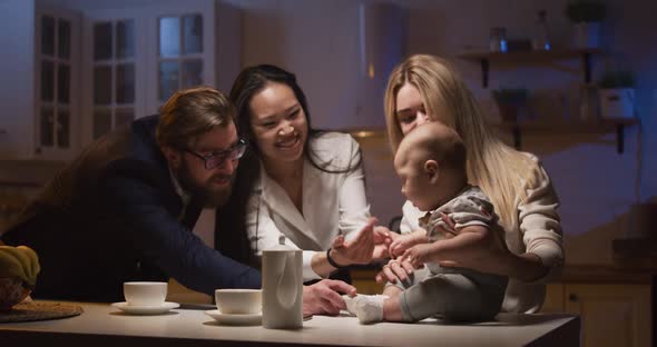 Parents Picking Up Baby From a Babysitter