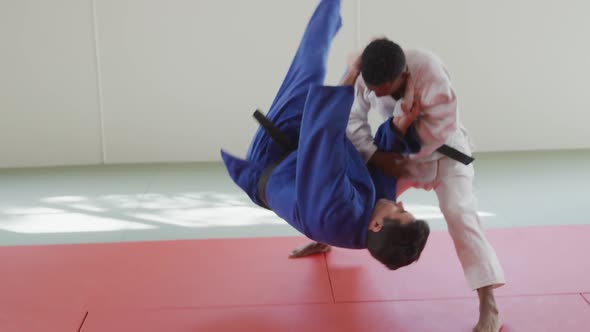 Judokas training by doing a randori on the judo mat