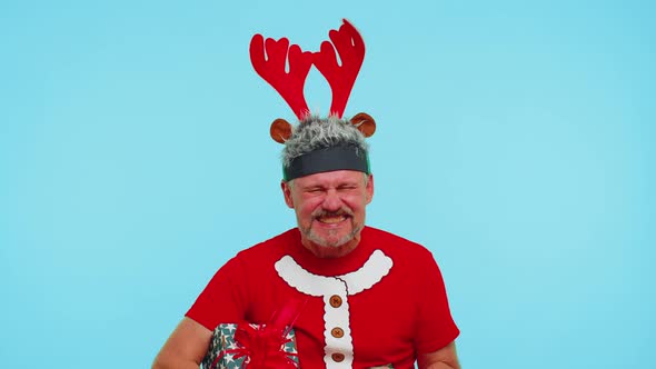 Upset Angry Man in Christmas Deer Antlers Raising Hands in Indignant Expression Quarreling Conflict