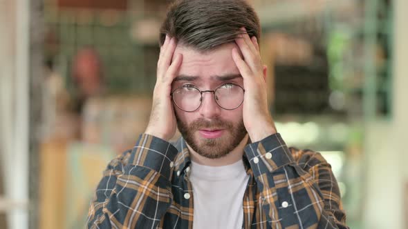 Portrait of Young Man Reacting To Loss, Failure 