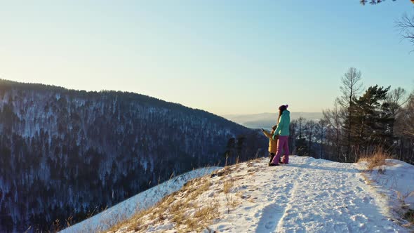 Mother and Son on the Top of the Mountain Enjoying the Sunset