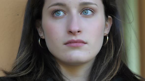 estranged from reality - young woman looks away in sad thoughts