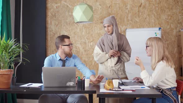 Muslim Woman Is Helping To Her Male and Female Colleagues in Office