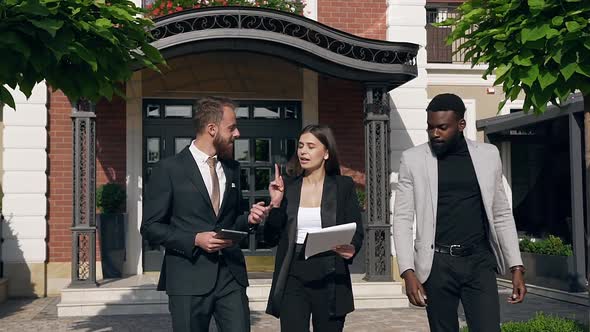 Pretty Businesswoman with Documents in her Hands Discussing