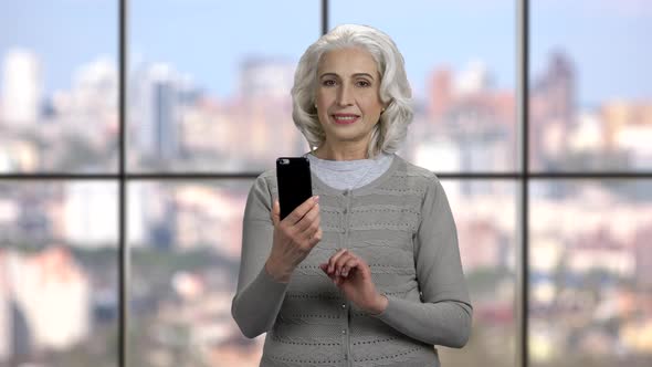 Mature Woman Taking Selfie with Telephone