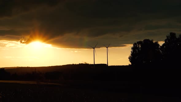 Wind Turbines spinning in the sunset (Loop)