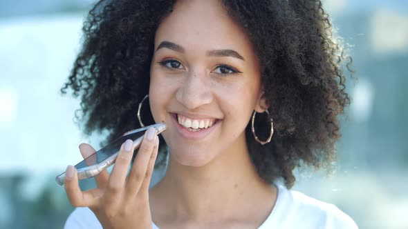 Beautiful African Girl Talking with Friend By Mobile Phone