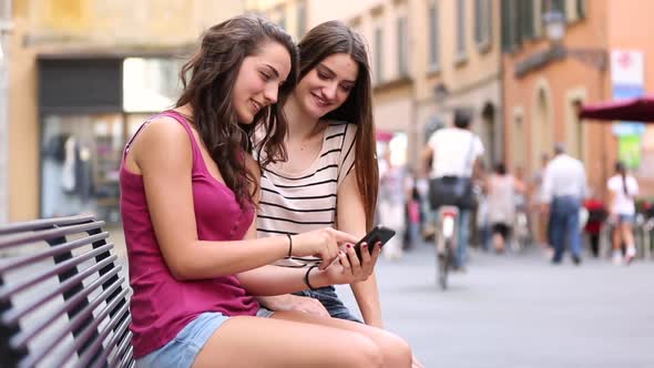 Two girls looking at a smartphone