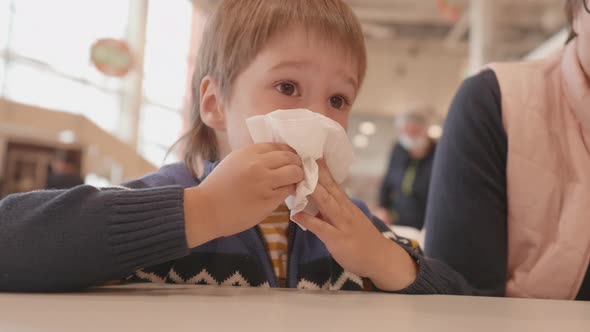 Little Boy Wipes His Mouth with Napkin