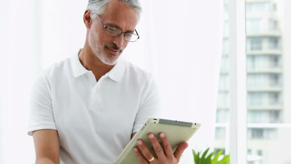 Smiling man using his tablet