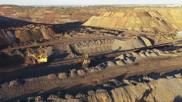 Heavy Mining Machinery in a Quarry at the Sunset