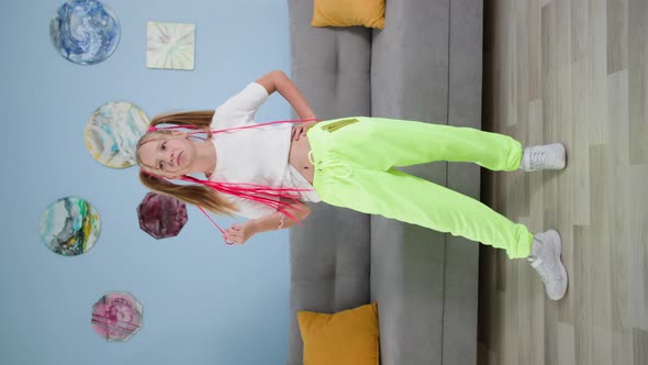 Trendy Girl with Colorful Pigtails Records Video on Mobile Phone at Home Blogger Child Shoot New