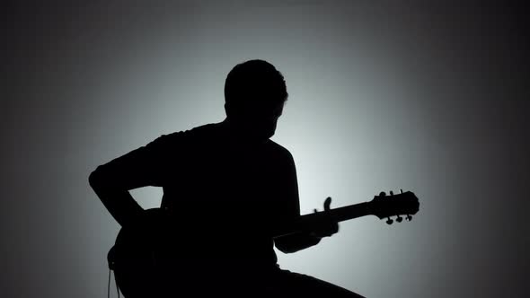 Silhouette of a Man with an Electric Guitar