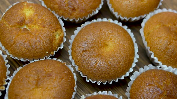 Baking Muffins Spinning On A Turntable, Mouth Watering Muffins Top View.