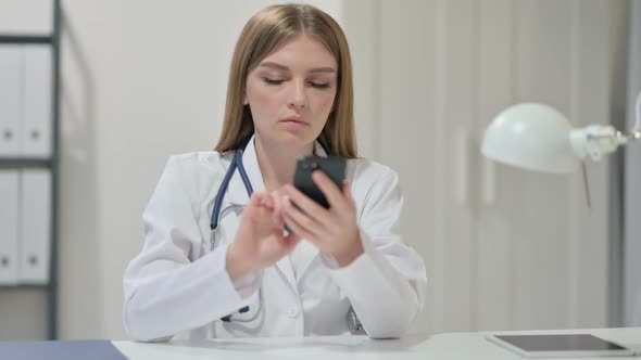 Female Doctor Using Smartphone at Work