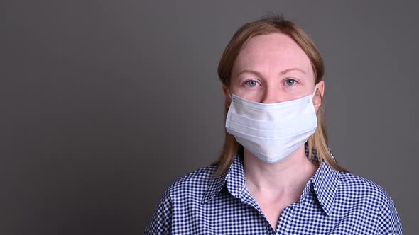 The Girl Protects Herself with a Medical Mask. Security of the House and Surroundings. Spread of