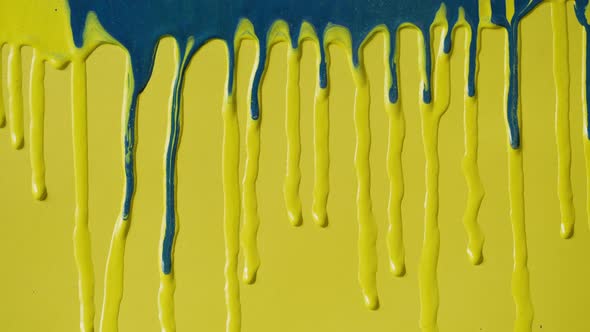 Blue Paint Background Color Tint Drops on Yellow Wall Closeup