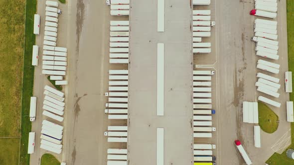 Aerial view. goods distribution warehouse. Semi trucks loading cargo containers. Logistics export an