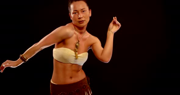 Young Caucasian Woman Is Dancing Belly Dance, Wearing Ethnic Jewelry, Studio Shot