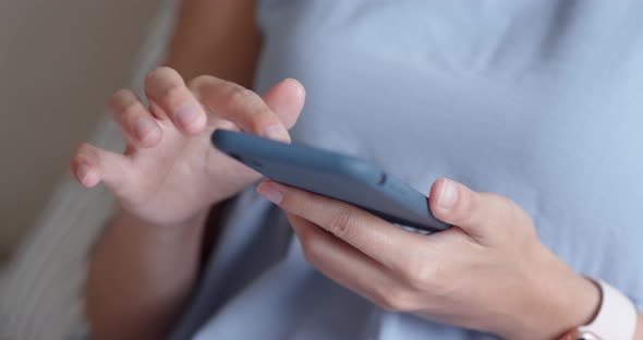 Woman use of mobile phone at home