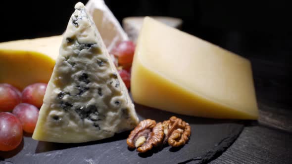 Cheese Plate Close-up with Several Varieties of Fruit and Cheese