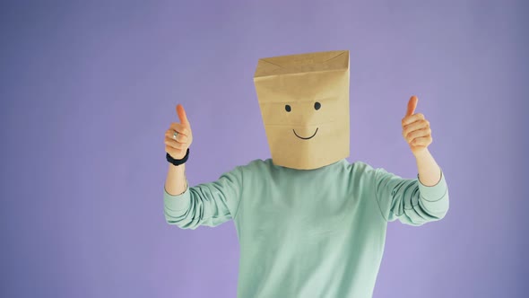 Person with Paper Bag on Head Showing Thumbs-up Gesture and Moving Body Dancing